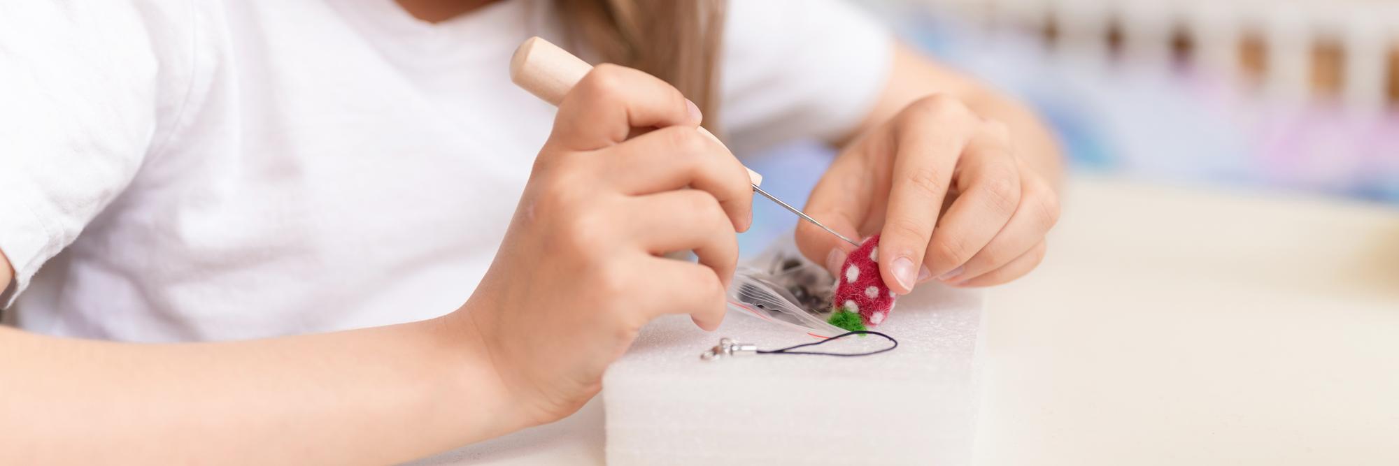 Teacher demonstrating stitch on hoop